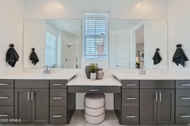 a bathroom with a double vanity sink and a mirror