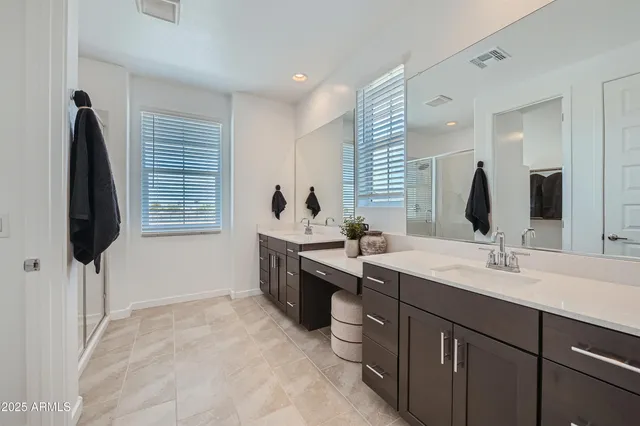 a bathroom with a double vanity sink and mirror