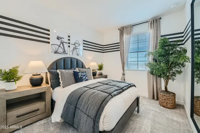 a bedroom with bed and a potted plant