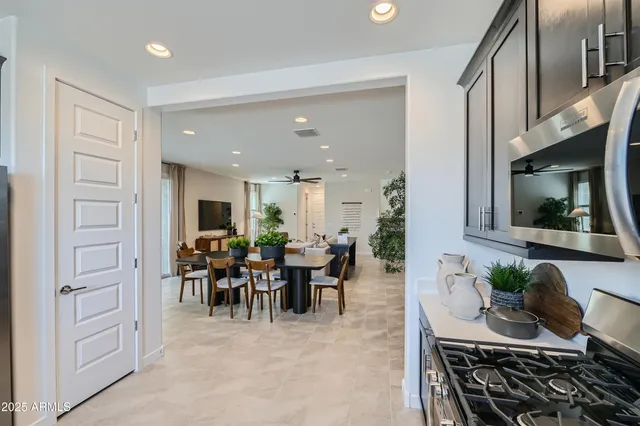 a kitchen with granite countertop a refrigerator and a stove top oven