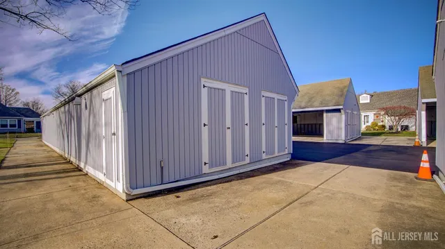 a view of a house with backyard and wooden fence