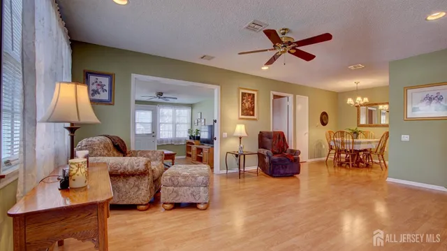 a living room with furniture and a chandelier