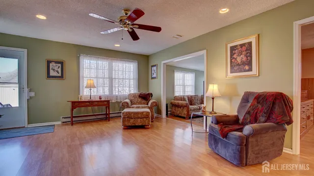 a living room with furniture window and wooden floor