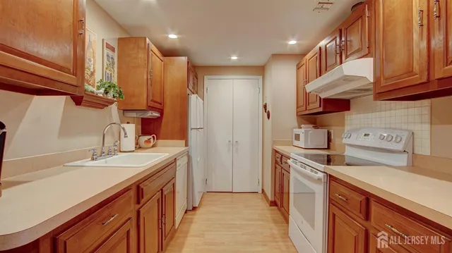 a kitchen with a sink stove and cabinets