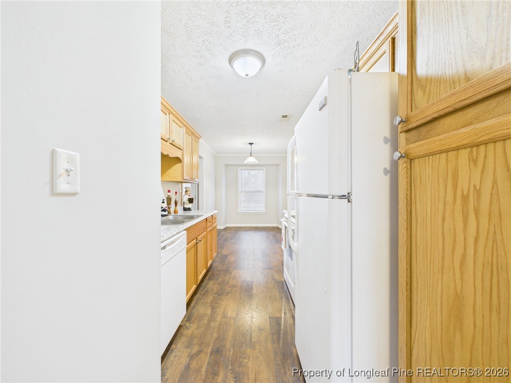 4403 Bishamon Street Hope Mills, NC 28348 - Photo 11 of 41 a view of a kitchen with a refrigerator and a window