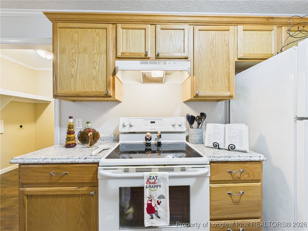 4403 Bishamon Street Hope Mills, NC 28348 - Photo 15 of 41 a kitchen with a stove and a cabinets