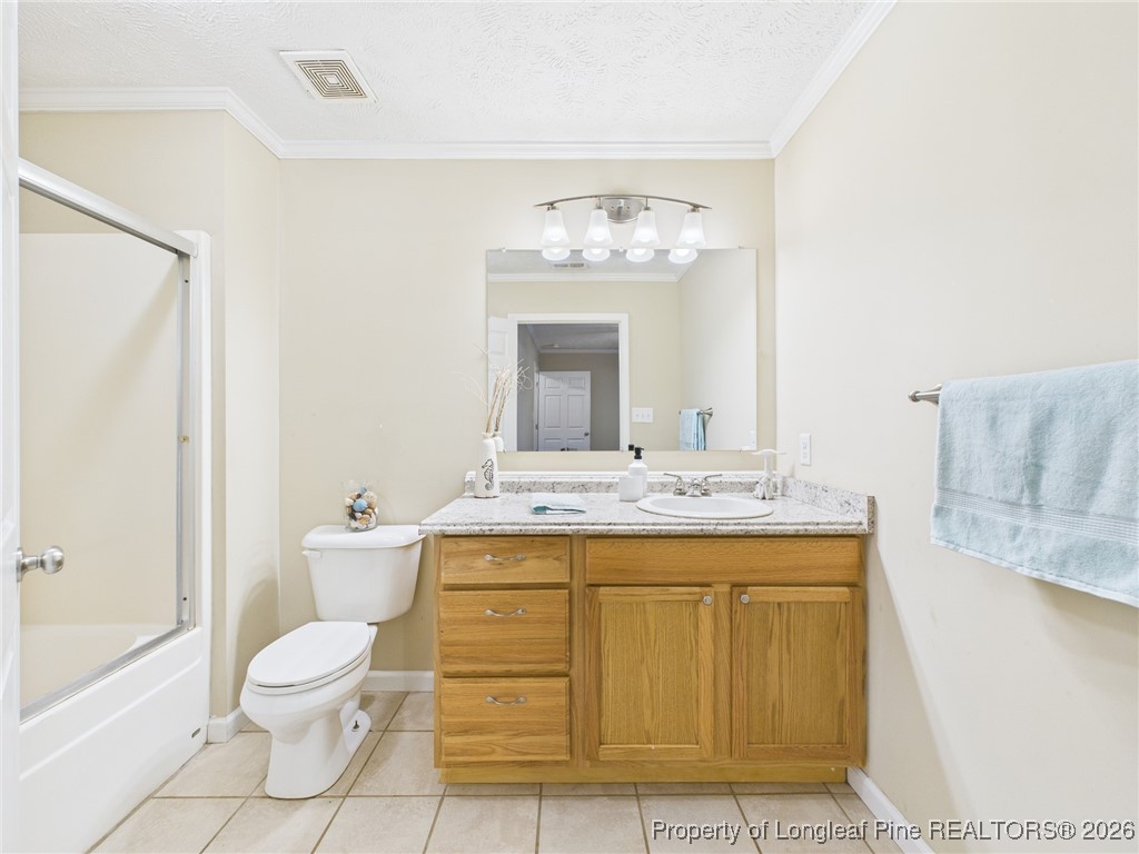 4403 Bishamon Street Hope Mills, NC 28348 - Photo 23 of 41 a bathroom with a granite countertop sink a toilet and a bathtub