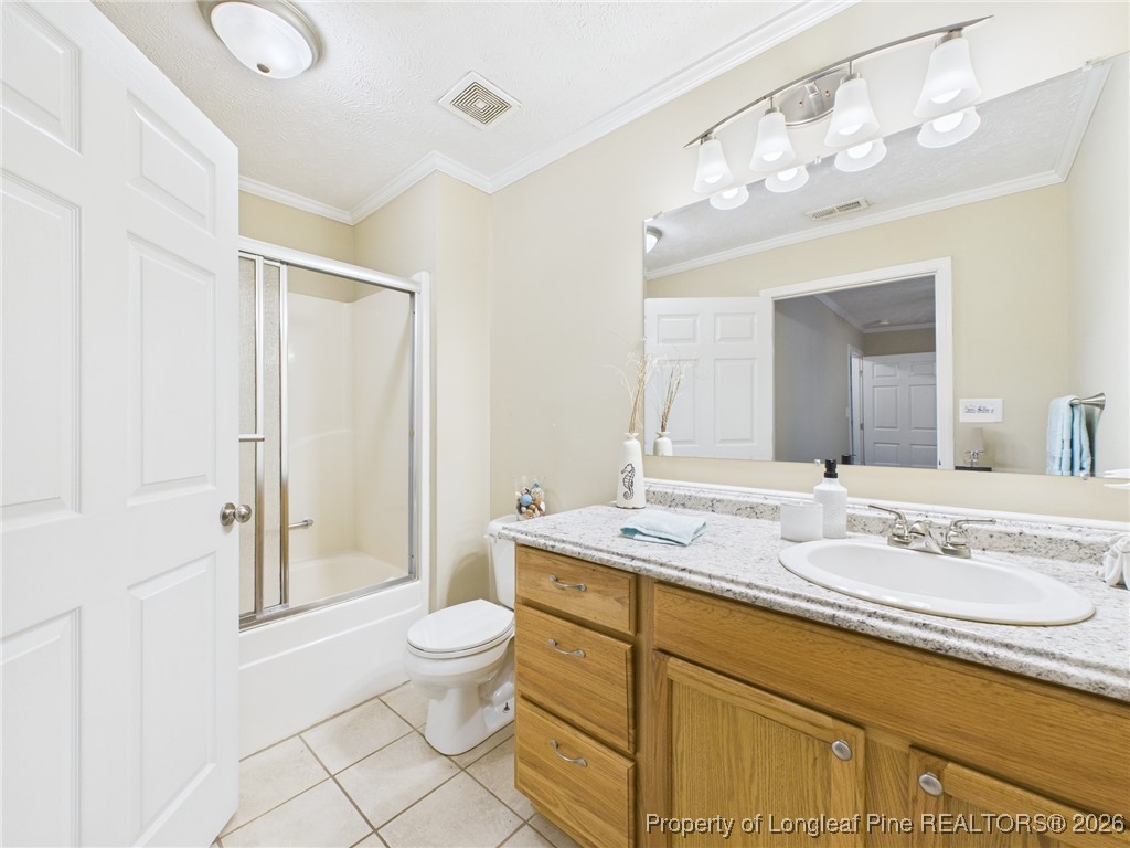 4403 Bishamon Street Hope Mills, NC 28348 - Photo 24 of 41 a spacious bathroom with a granite countertop sink a toilet a mirror and shower