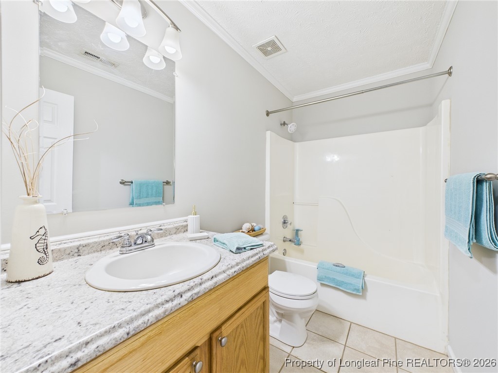 4403 Bishamon Street Hope Mills, NC 28348 - Photo 29 of 41 a bathroom with a granite countertop sink a mirror and a toilet