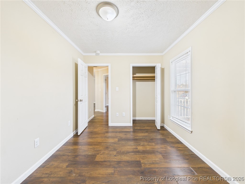 4403 Bishamon Street Hope Mills, NC 28348 - Photo 33 of 41 a view of an empty room with wooden floor and a window