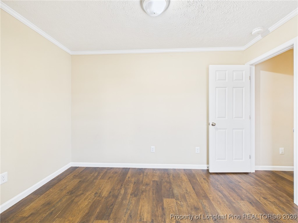 4403 Bishamon Street Hope Mills, NC 28348 - Photo 34 of 41 a view of a room with wooden floor and white walls