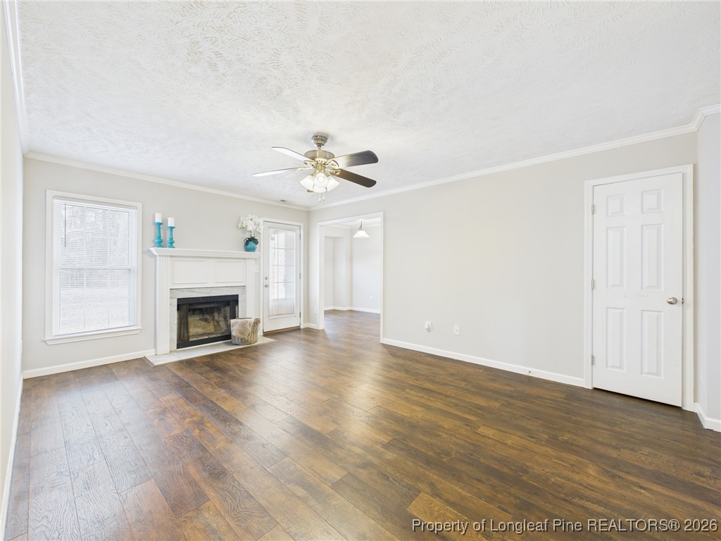 4403 Bishamon Street Hope Mills, NC 28348 - Photo 9 of 41 a view of an empty room with wooden floor and fireplace