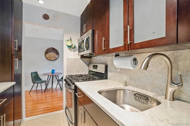a kitchen with stainless steel appliances granite countertop a sink and cabinets