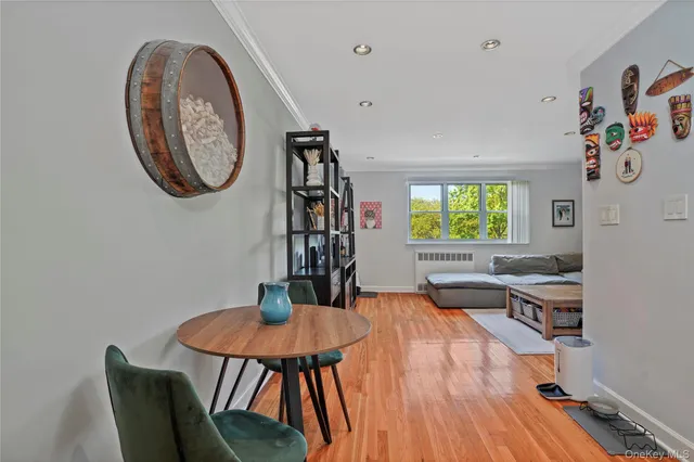 a view of a dining room with furniture and a potted plant
