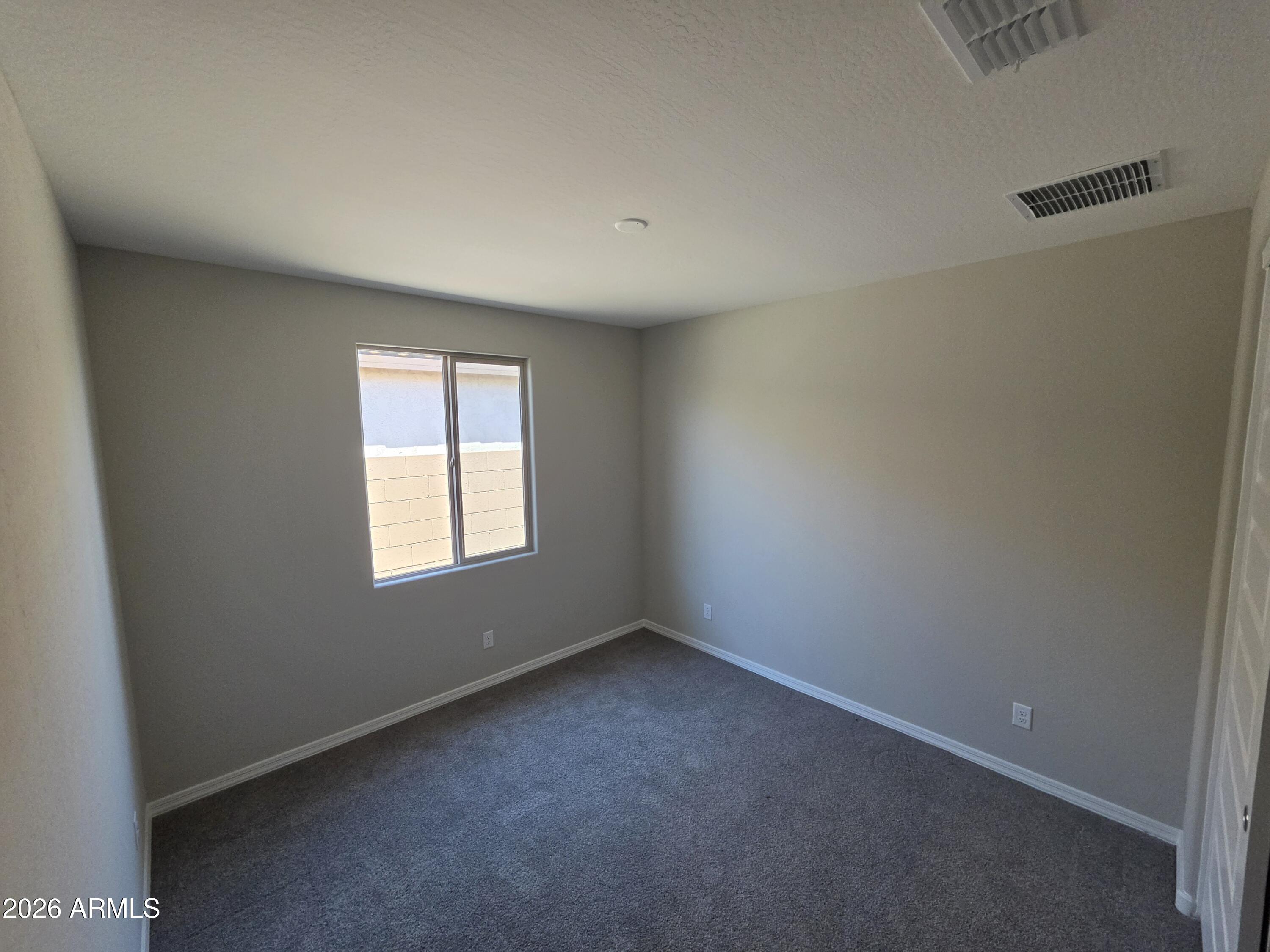 7128 West Coles Road Laveen, AZ 85339 - Photo 30 of 38 an empty room with a window