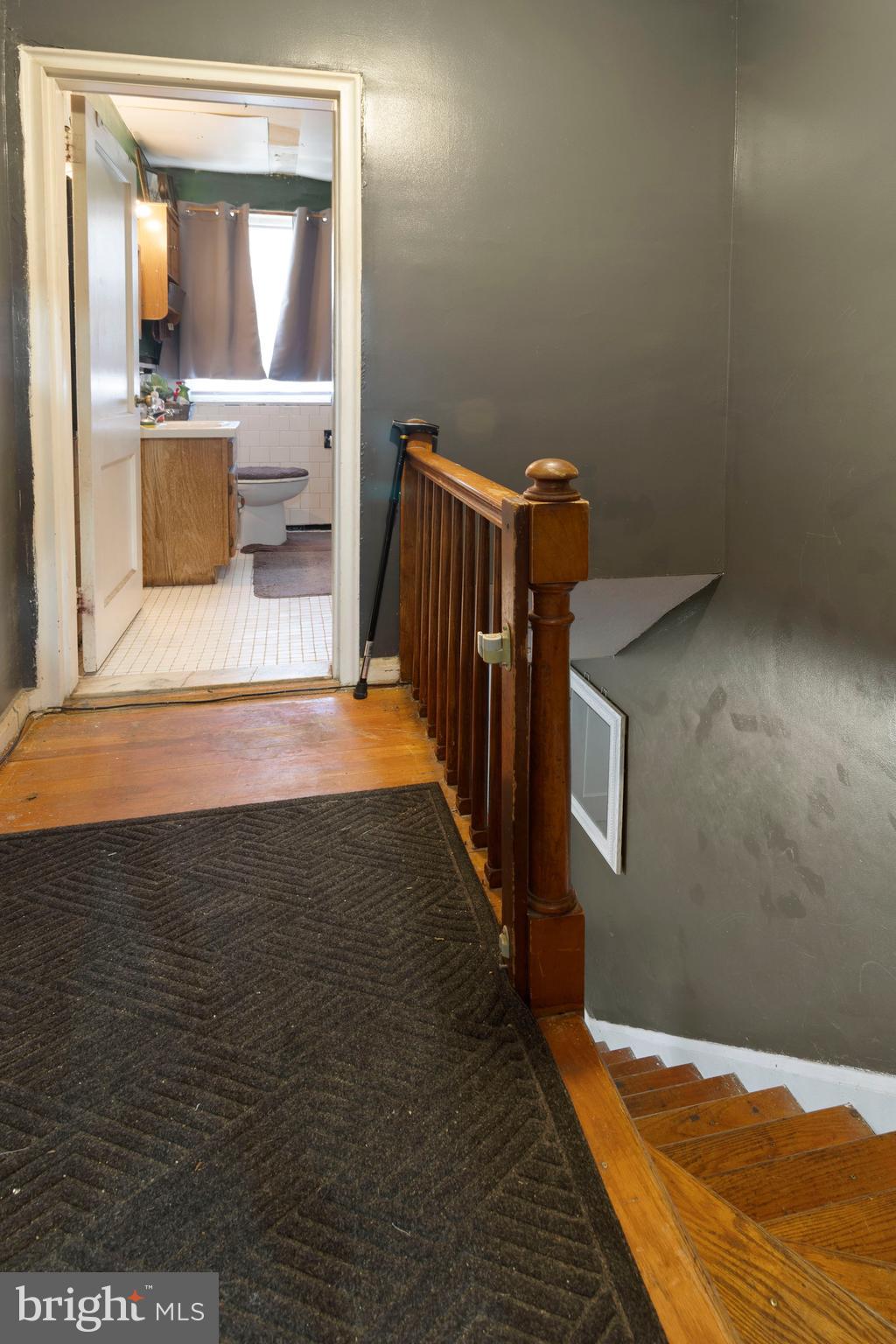 5425 Whitlock Road Baltimore, MD 21229 - Photo 16 of 30 a view of an empty room and bathroom with wooden floor