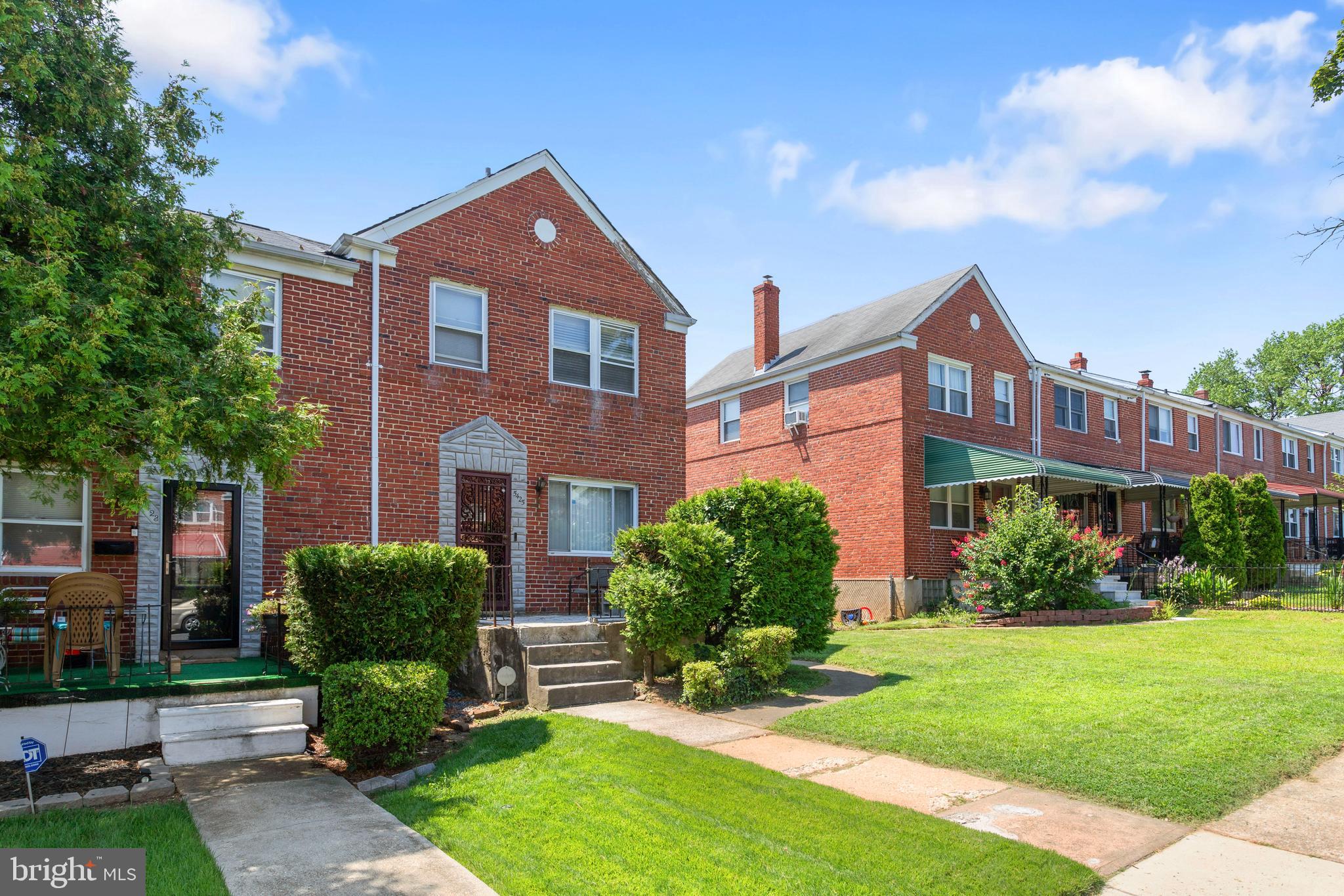 5425 Whitlock Road Baltimore, MD 21229 - Photo 2 of 30 a front view of a house with a yard and potted plants