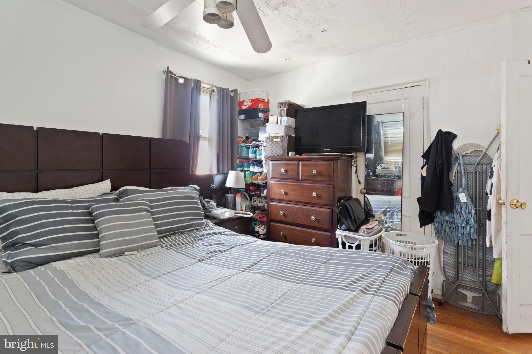 5425 Whitlock Road Baltimore, MD 21229 - Photo 23 of 30 a bedroom with a bed and flat screen tv