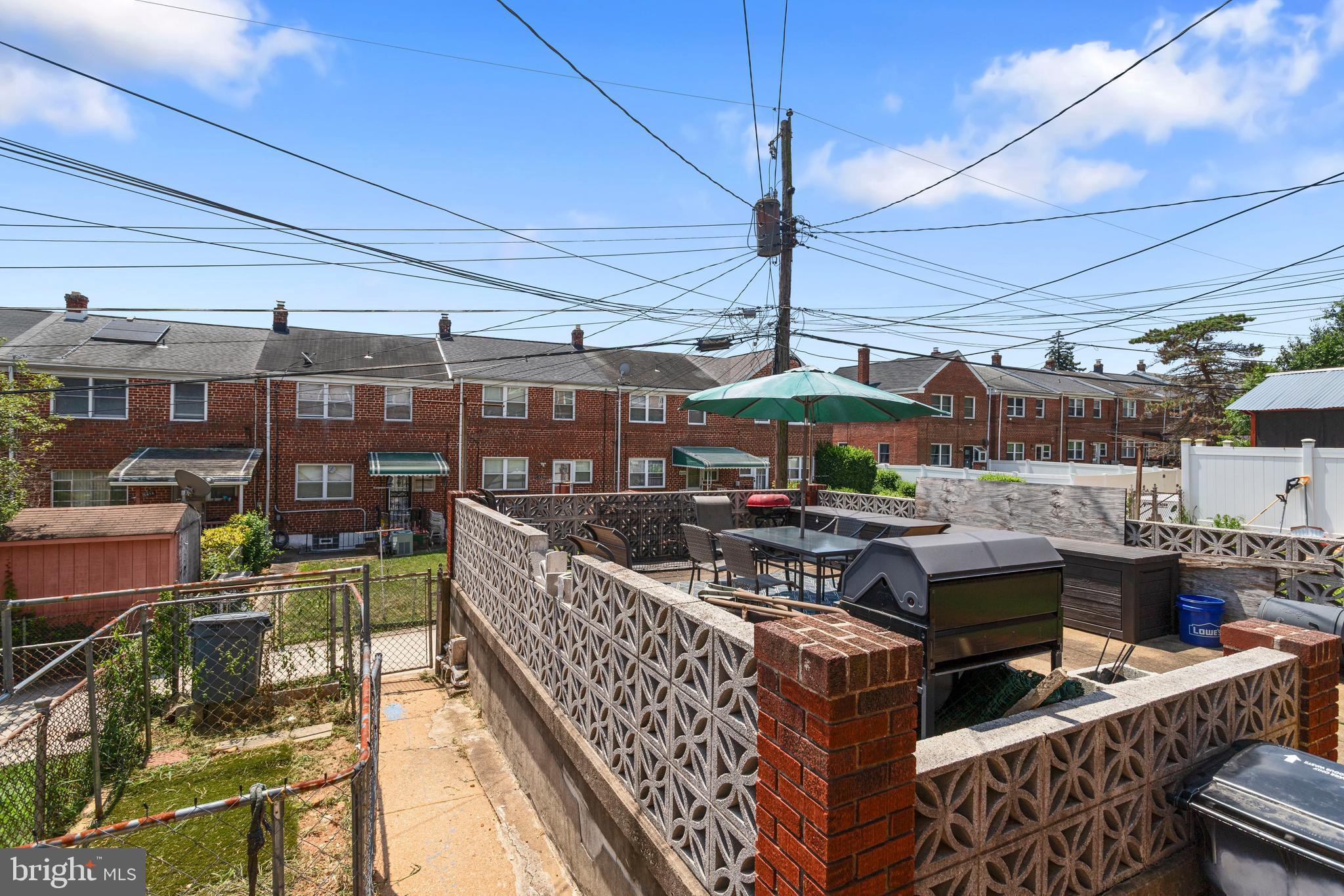 5425 Whitlock Road Baltimore, MD 21229 - Photo 26 of 30 a view of a patio with couches under an umbrella