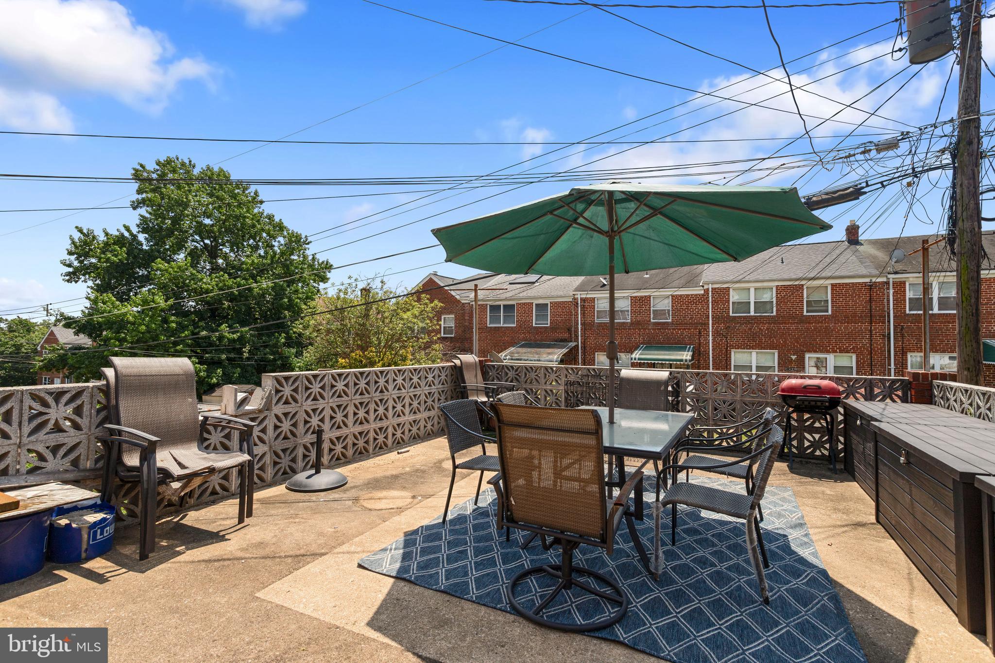 5425 Whitlock Road Baltimore, MD 21229 - Photo 27 of 30 an outdoor space with furniture and umbrella