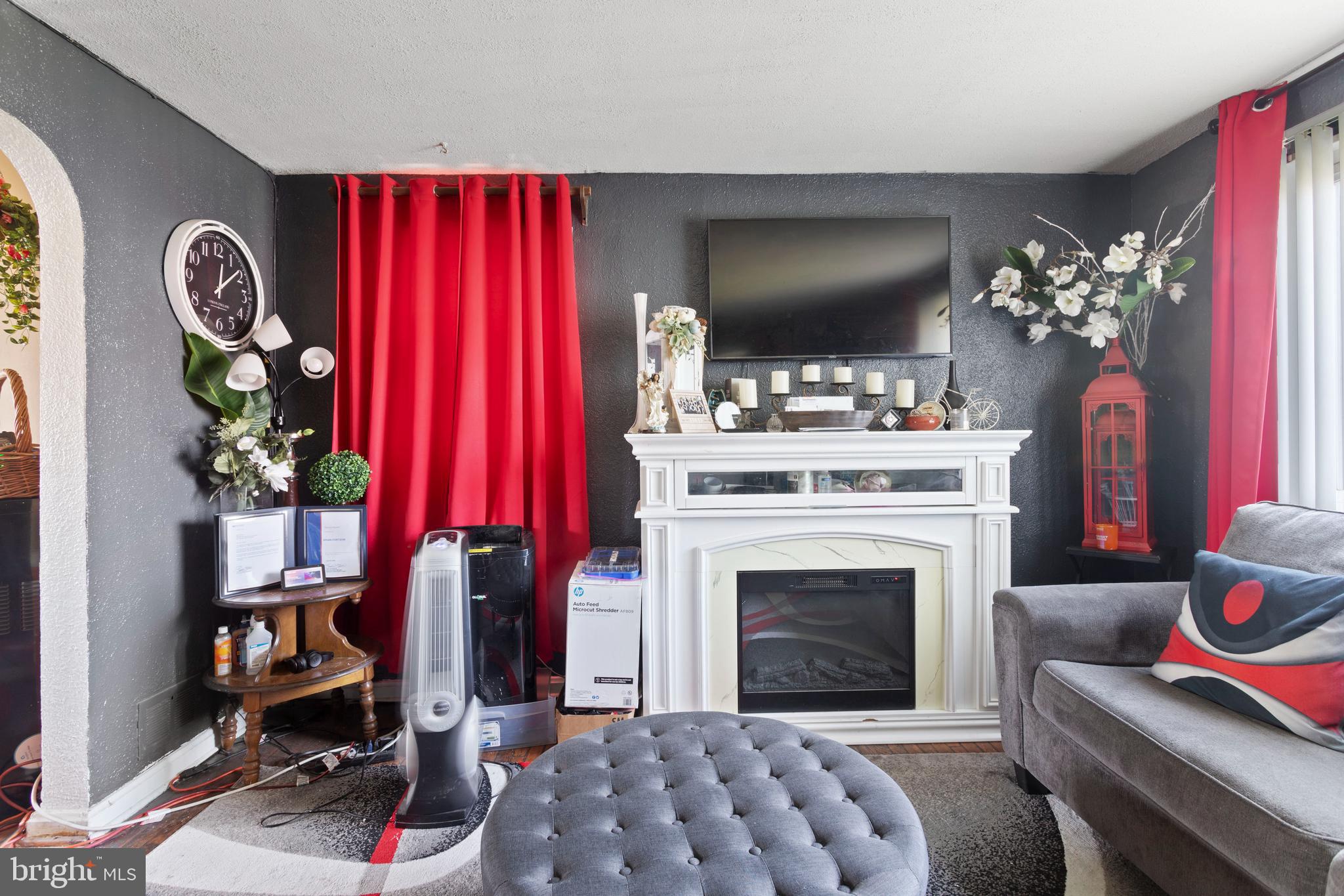5425 Whitlock Road Baltimore, MD 21229 - Photo 5 of 30 a living room with furniture a flat screen tv and a fireplace