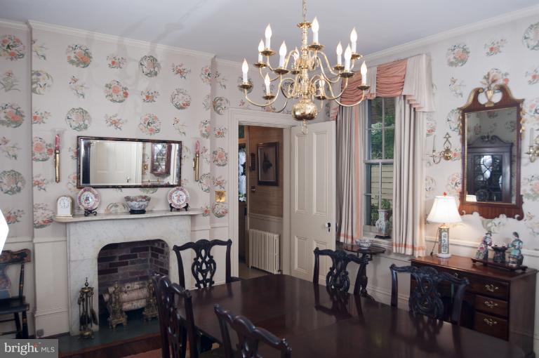 101 East 2nd Street Frederick, MD 21701 - Photo 25 of 30 a dining room with wooden floor a chandelier a wooden table and chairs