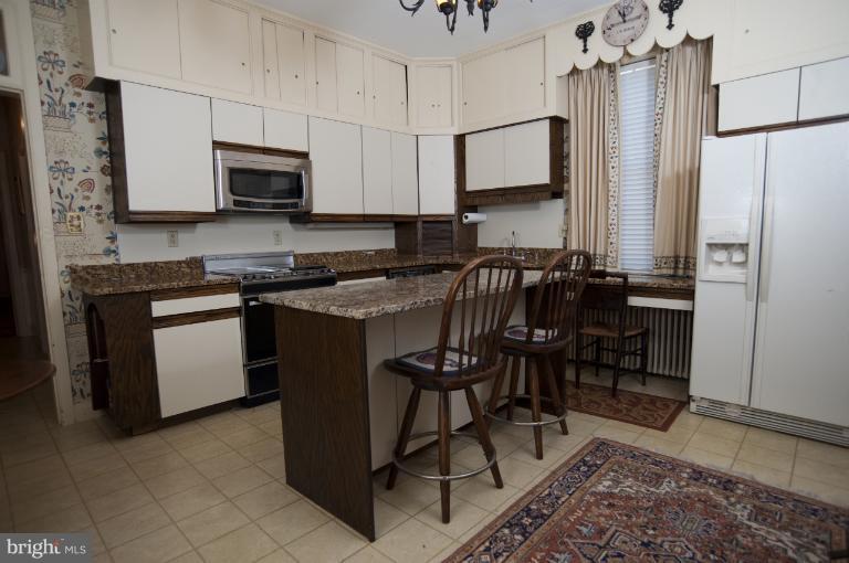 101 East 2nd Street Frederick, MD 21701 - Photo 8 of 30 a kitchen with stainless steel appliances a stove a sink a microwave a refrigerator and cabinets