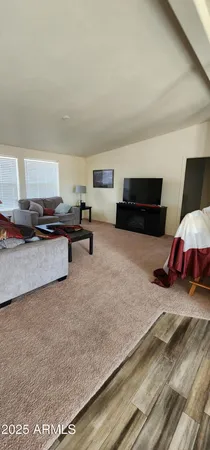 a living room with furniture and kitchen view
