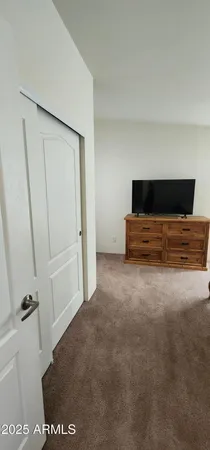 a room with a bed and a dresser