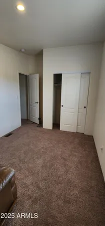 a bathroom with a granite countertop sink mirror vanity and toilet