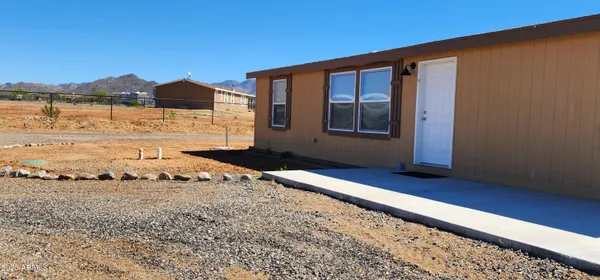 a view of a house with a backyard