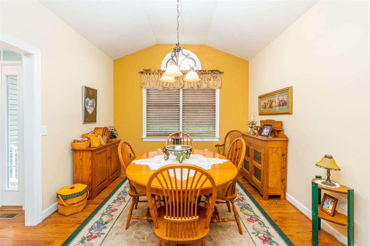 283 Round Hill School Road Fort Defiance, VA 24437 - Photo 18 of 48 a dining room with furniture and a chandelier