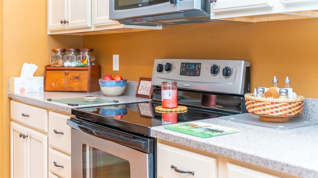 283 Round Hill School Road Fort Defiance, VA 24437 - Photo 25 of 48 a kitchen with stainless steel appliances granite countertop a stove and a microwave