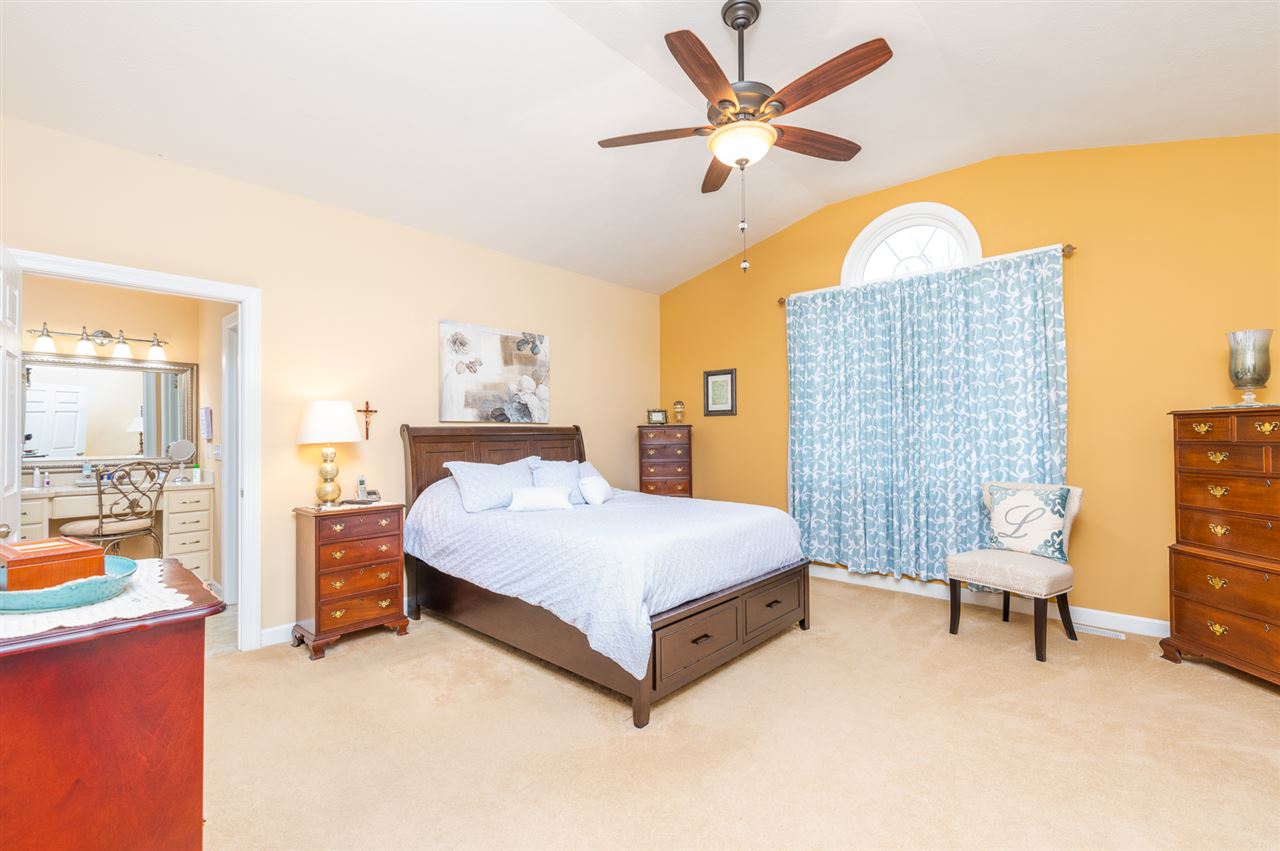 283 Round Hill School Road Fort Defiance, VA 24437 - Photo 29 of 48 a spacious bedroom with a bed and a chandelier