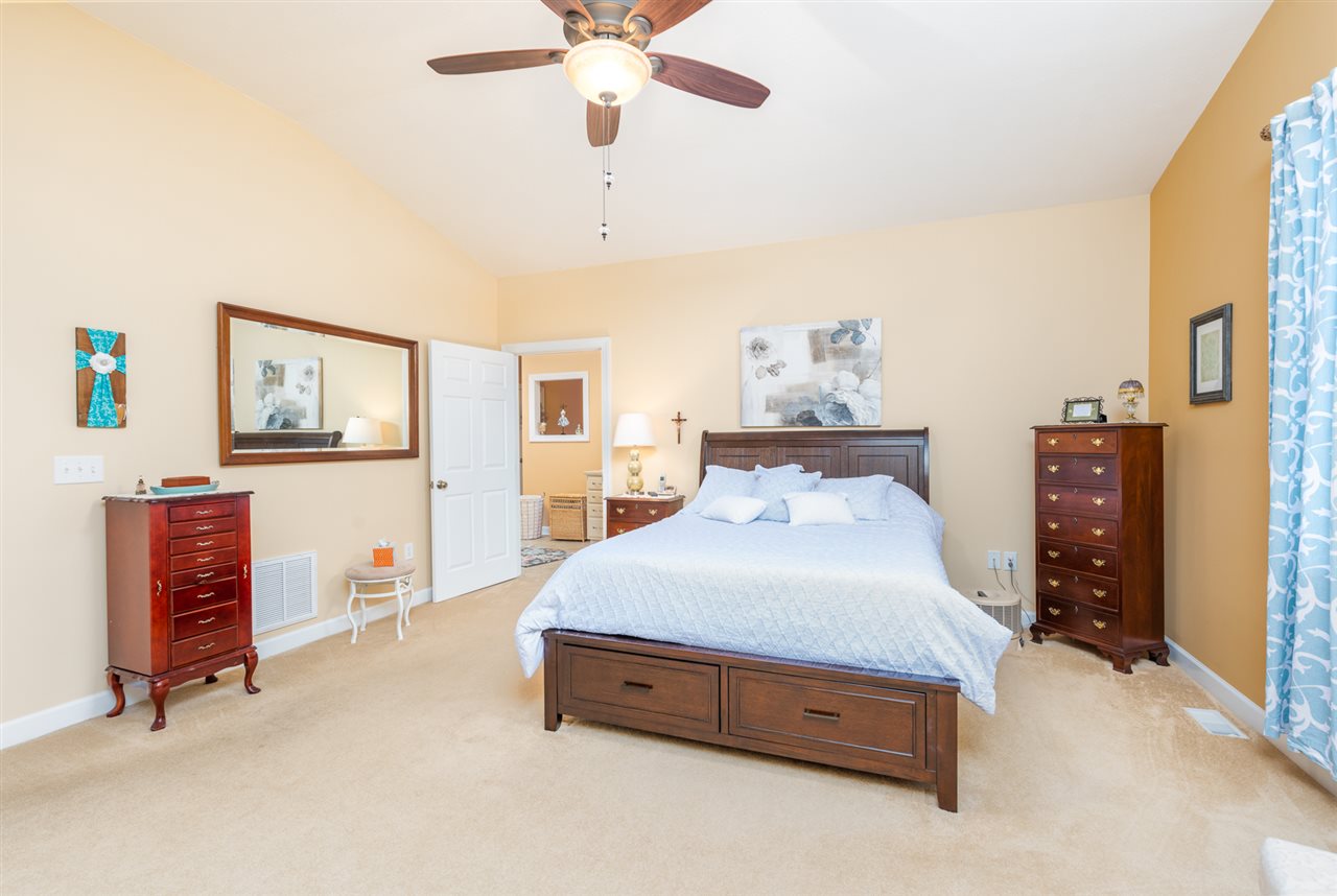 283 Round Hill School Road Fort Defiance, VA 24437 - Photo 36 of 48 a spacious bedroom with a bed and a chandelier