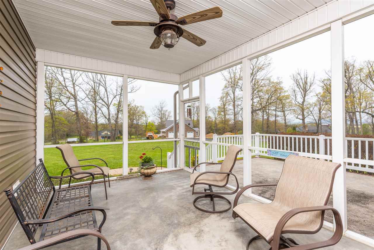 283 Round Hill School Road Fort Defiance, VA 24437 - Photo 7 of 48 a living room with patio chairs and a floor to ceiling window