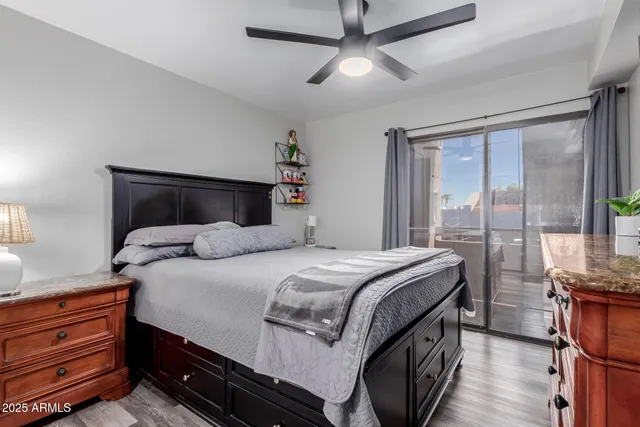 a bedroom with a large bed and wooden floor