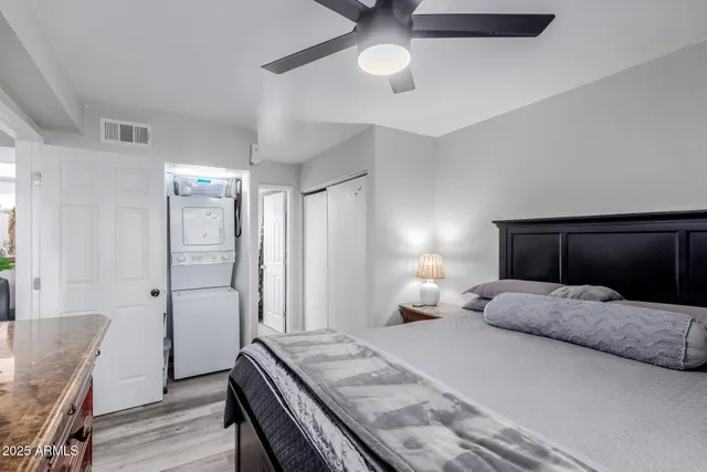 a bedroom with furniture and a flat screen tv