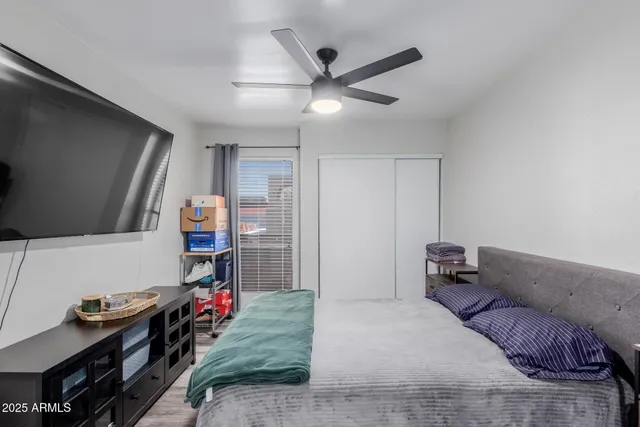 a bedroom with a bed and a flat screen tv