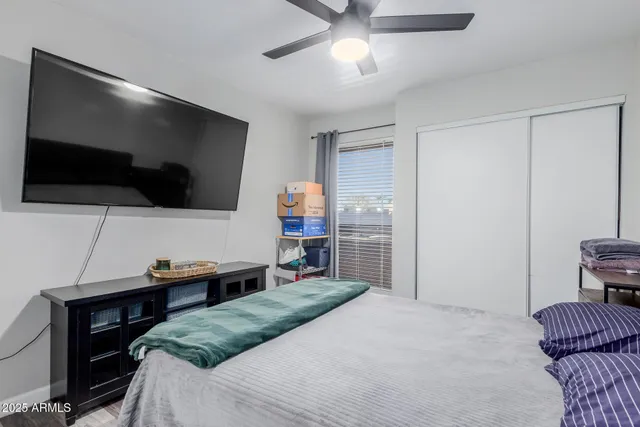 a bedroom with a bed and a chandelier