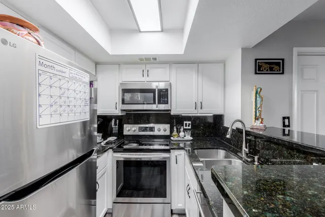 a kitchen with a stove a sink and a microwave