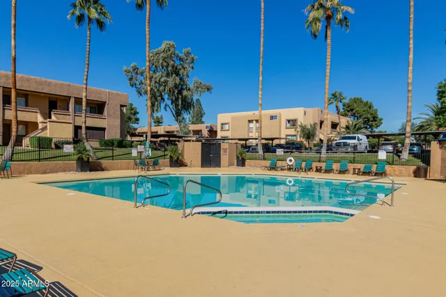 a view of a swimming pool with a deck and plants