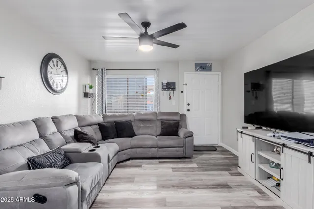 a living room with furniture and a flat screen tv