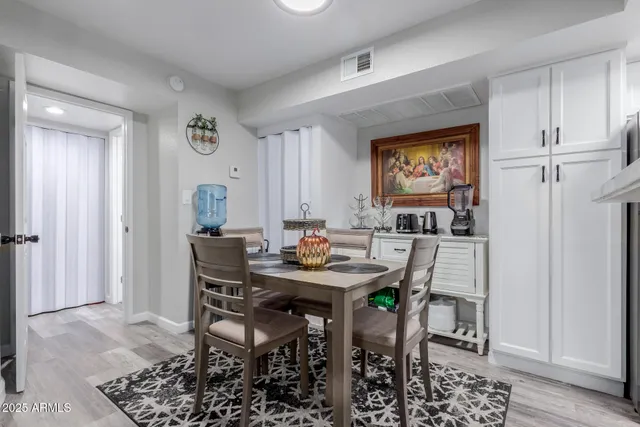 a kitchen with refrigerator and white cabinets