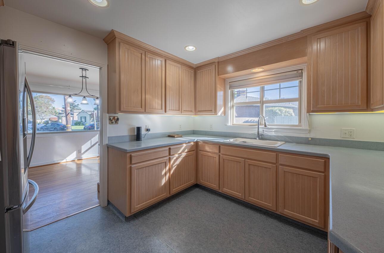 194 Riker Terrace Salinas, CA 93901 - Photo 12 of 36 a kitchen with granite countertop white cabinets and sink