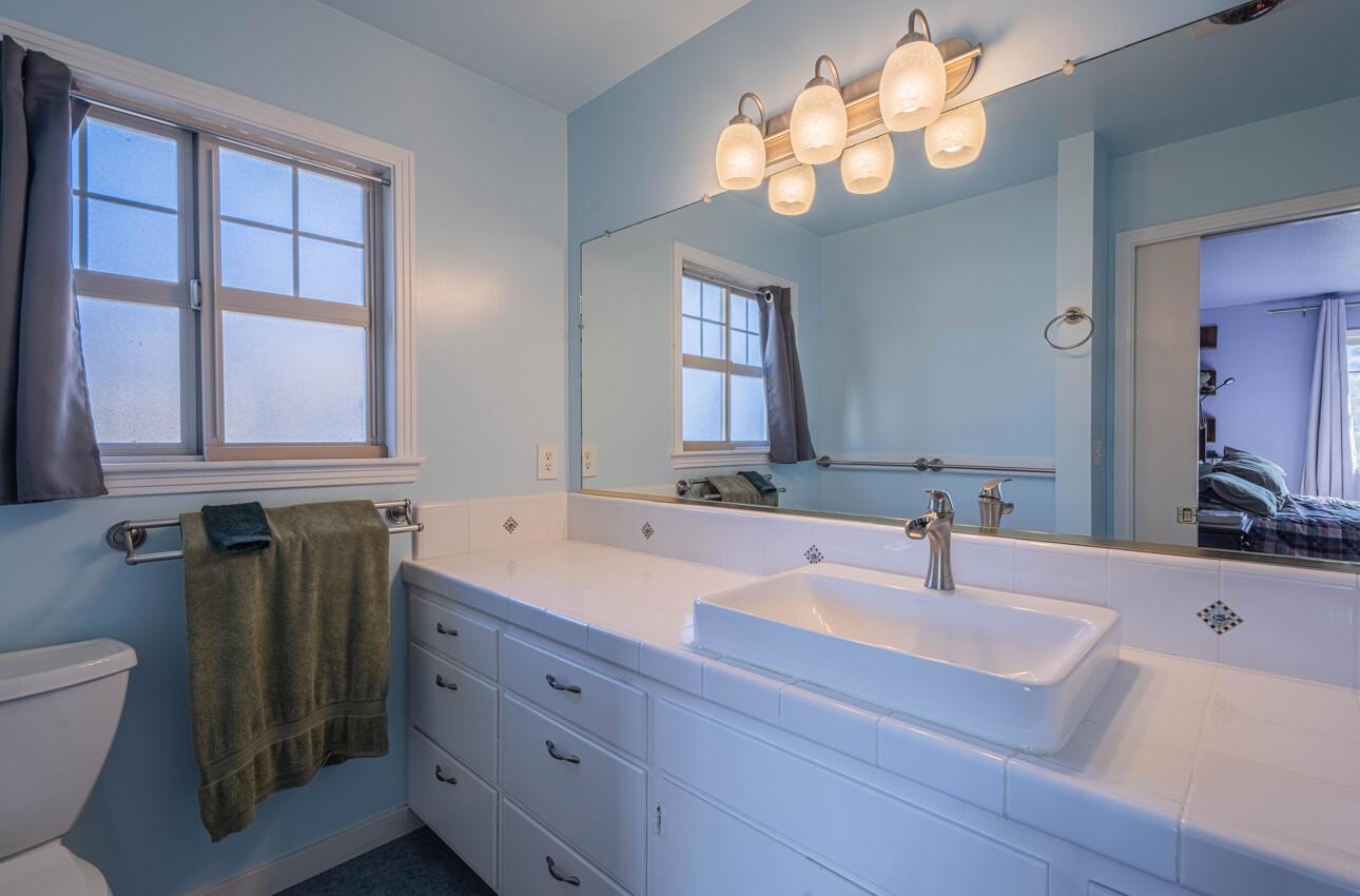 194 Riker Terrace Salinas, CA 93901 - Photo 24 of 36 a bathroom with a sink and a large mirror
