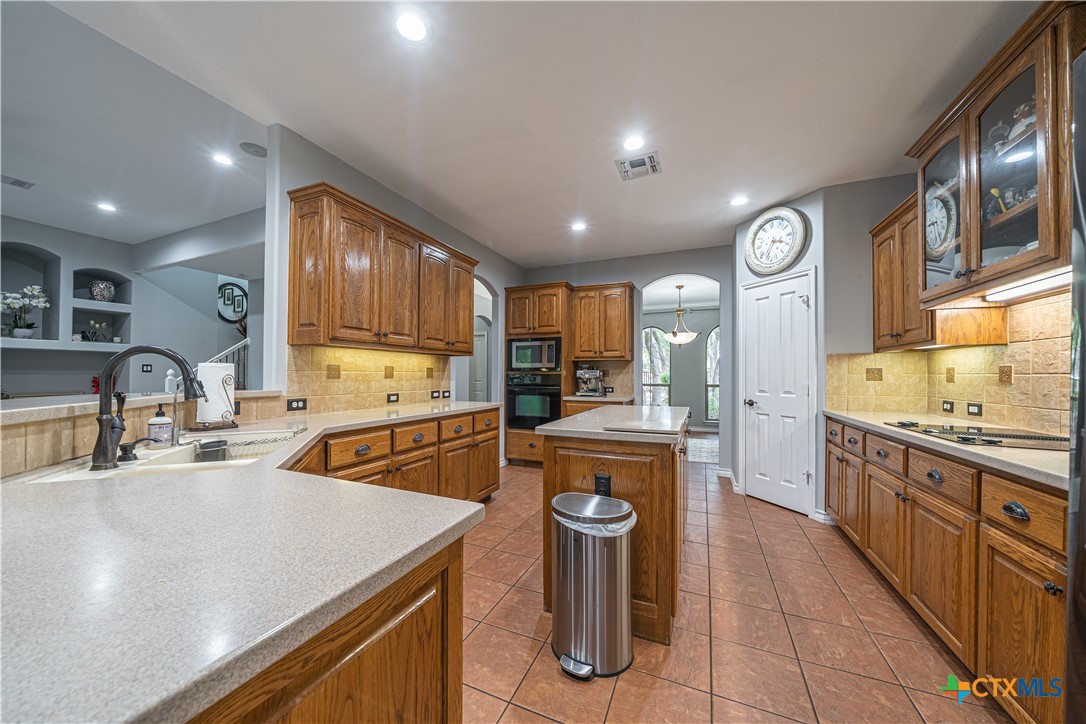 519 Long Meadow Spring Branch, TX 78070 - Photo 11 of 33 a kitchen with stainless steel appliances granite countertop a sink a stove and a refrigerator