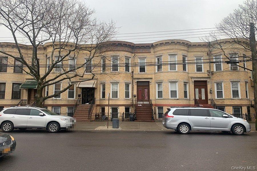 59-28 Summerfield Street, Unit 2 Queens, NY 11385 - Photo 1 of 2 a view of a cars parked in front of a white house