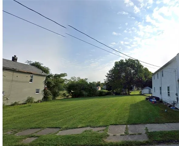 a view of a backyard with plants and garden