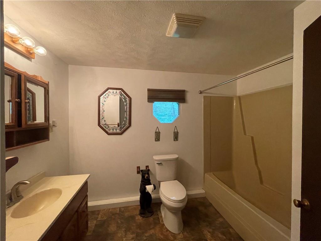 474 Iron Rock Road Waynesburg, PA 15370 - Photo 15 of 15 a bathroom with a toilet sink vanity tub and mirror